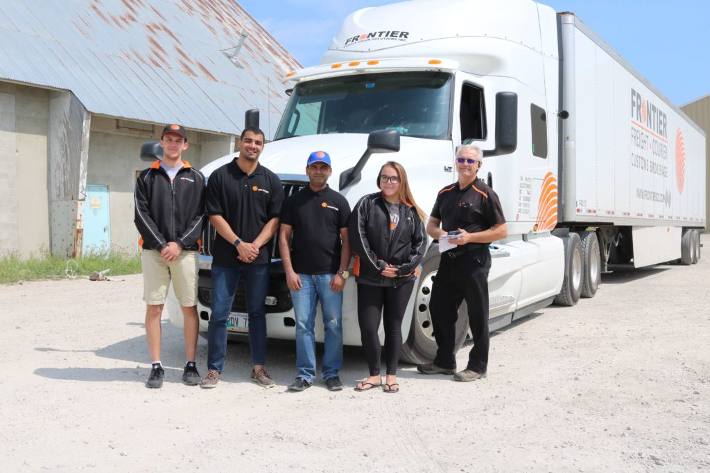 Frontier Employees in front of truck